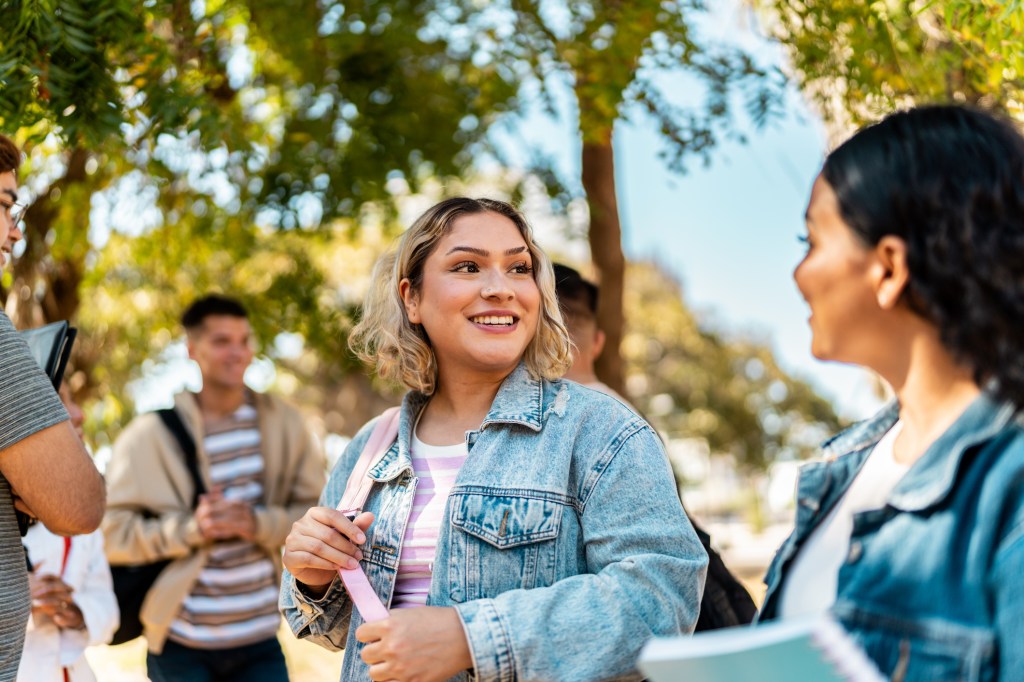 Young student women talking and walking outdoors